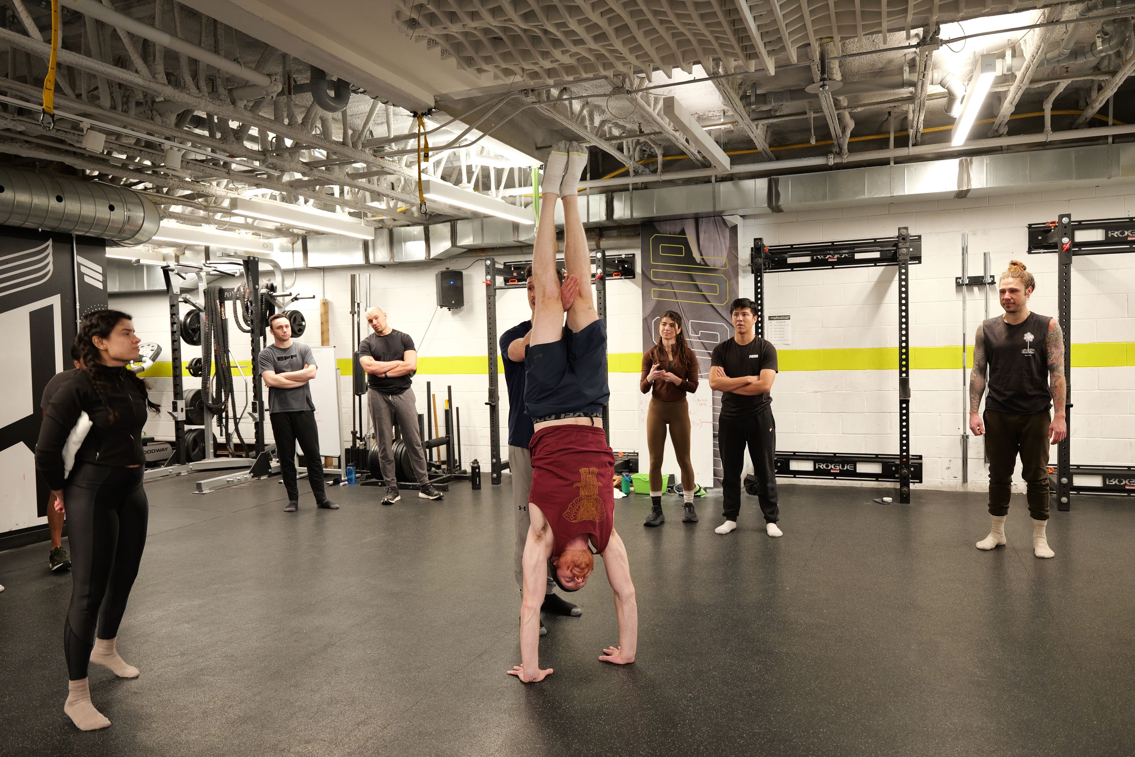 Freestanding handstand in the center of the floor while the class watches